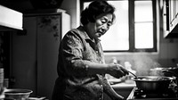 A photo of chinese aunt cooking.  