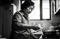 A photo of chinese aunt cooking.  