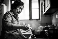 A photo of chinese aunt cooking.  