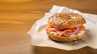 Close-up of Lox Bagel with onions on paper sheet.  