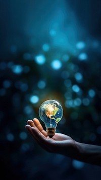 close-up remix photo of hand holding a light bulb with the earth inside.  