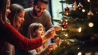 closeup photo of family decorating a Christmas tree.  