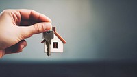 close up photo of black hand holding house key.  