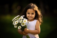 Child portrait holding flower. 