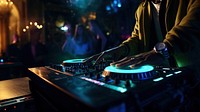 a photo of dj hand putting the music in a club.  