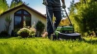 Photo of a man tending to lawn. 