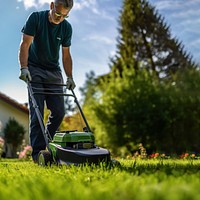 Photo of a man tending to lawn. 