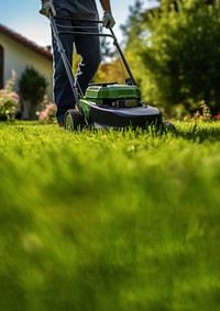 Photo of a man tending to lawn. 