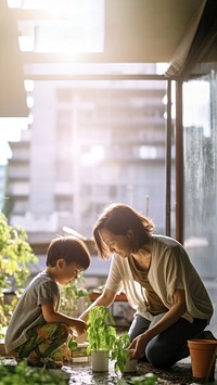 photo a Mother and son watering vegetables in their urban garden.  