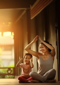 Photo of asia girl do yoga pose with her mom.  