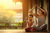 Photo of asia girl do yoga pose with her mom.  