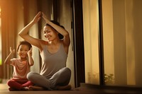 Photo of asia girl do yoga pose with her mom.  