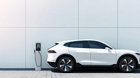 Photo of a white of SUV car at ev charging. 