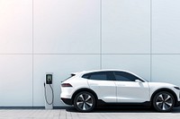 Photo of a white of SUV car at ev charging. 