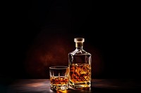 Photo of a whiskey glass and whiskey bottle. 