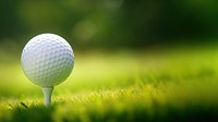 photo of a close up the golf ball on tee pegs ready to play, light green, natural light. 