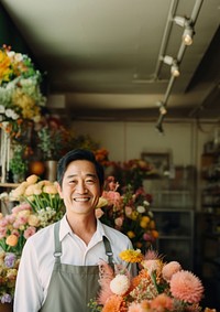 photo of local flower shop and asian man happy owner in front. 