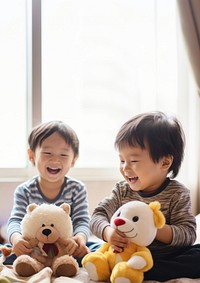 photo of two boys playing with toy stuff animals dolls together. 