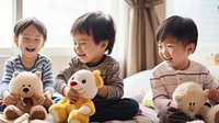 photo of two boys playing with toy stuff animals dolls together. 