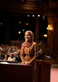 Young Muslim woman speaker on professional stage.  