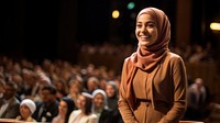 Young Muslim woman speaker on professional stage.  