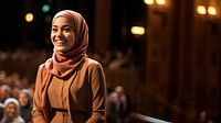 Young Muslim woman speaker on professional stage.  