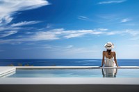 Woman sitting by the pool. 