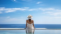 Woman sitting by the pool. 