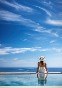 Woman sitting by the pool. 