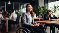 photo of a business woman in wheelchair presenting work in meeting room.  