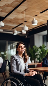 photo of a business woman in wheelchair presenting work in meeting room.  