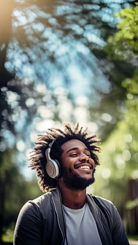 Happy man headphones listening outdoors.  