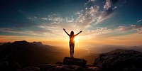 Carefree woman standing on the edge of mountain cliff. 