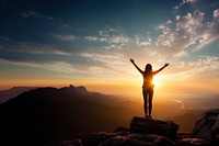 Carefree woman standing on the edge of mountain cliff. 