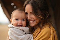 Woman holding adorable baby laughing portrait female. 