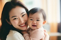 Woman holding adorable baby family happy togetherness. 