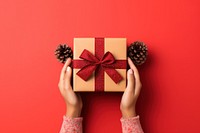 Christmas gift box holding hand red. AI generated Image by rawpixel.