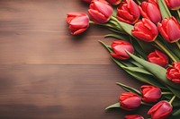 Woman making red tulips flower bouquet petal plant wood. 