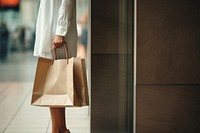 Woman holding shopping bags handbag architecture consumerism. 