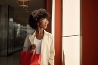 Black Woman holding shopping bags handbag architecture refrigerator. 