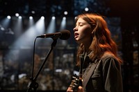 Girl singing microphone musician guitar.