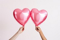 Two pink heart-shaped balloons photo. AI generated image by rawpixel.