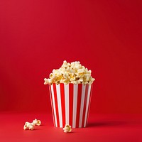 a photograph of a striped box with popcorn isolated on solid color background.  