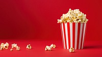 a photograph of a striped box with popcorn isolated on solid color background.  