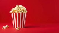 a photograph of a striped box with popcorn isolated on solid color background.  