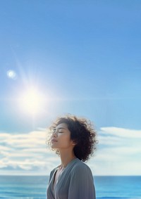 photo of woman praying with bluesky on the sea with blurred vision.  