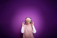 photo of a muslim woman wearing headphones.  