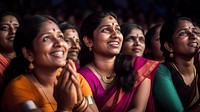 Photography of Unusual looking 36yo south Indian women speacking watching concert.  