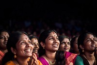 Photography of Unusual looking 36yo south Indian women speacking watching concert.  