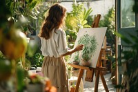 A young woman painting outdoors organic easel. 